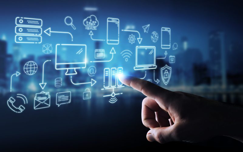 Businessman on blurred background using tech devices and icons thin line interface